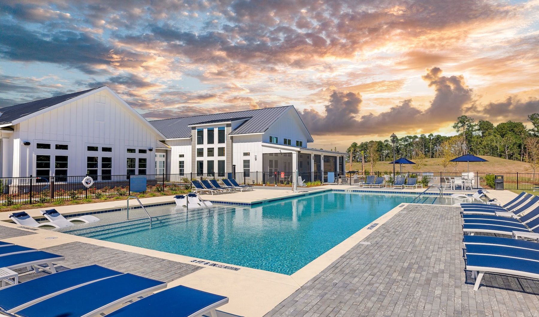 Resort-style swimming pool with lounging chairs